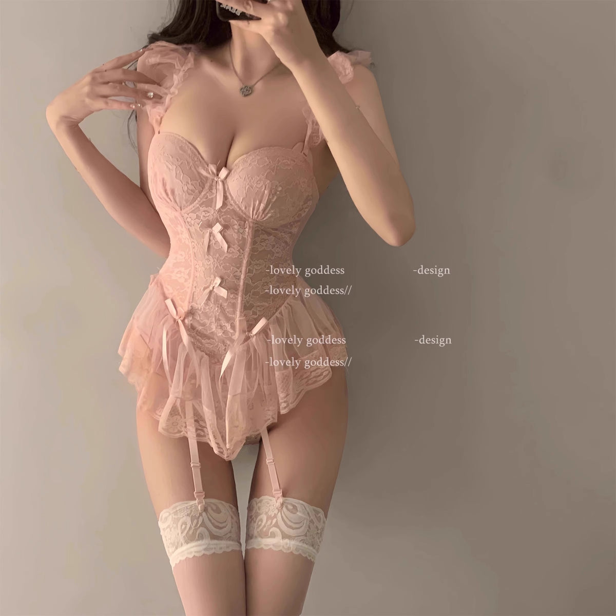 Closeup of removable strap hardware and delicate lace edge on pink corset sleepwear