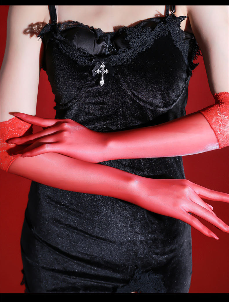 Red sheer opera gloves with red lace cuffs worn with a black dress and silver cross pendant