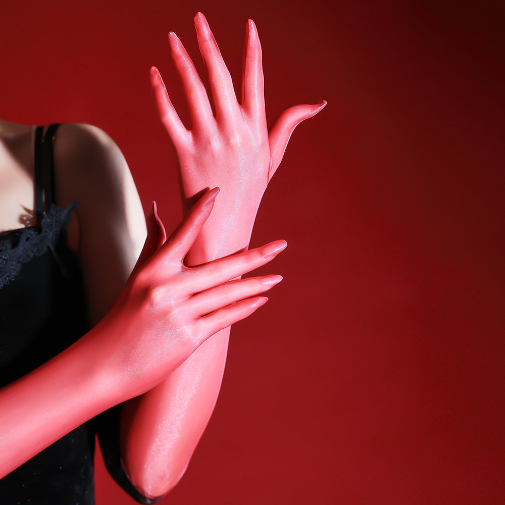 Close-up of a red sheer glove with a black lace cuff resting on a bare thigh