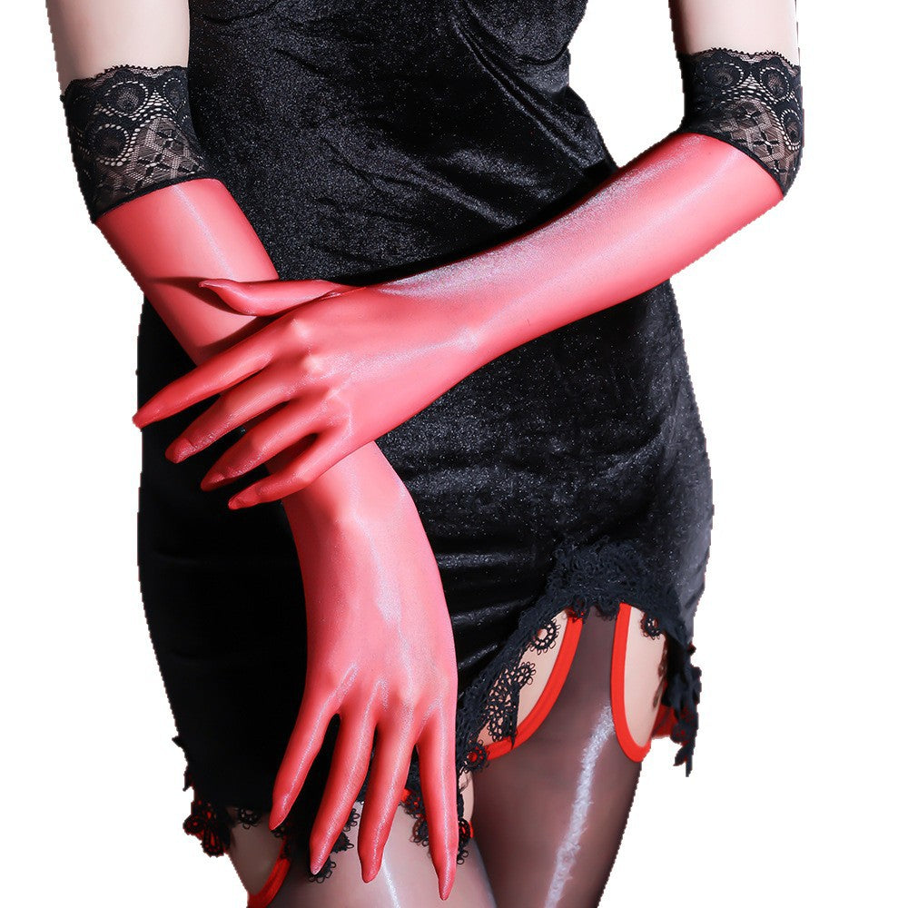 White opera-length sheer gloves with white lace cuffs, both hands raised against red