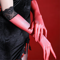 Close-up of black sheer five-finger gloves with a black lace cuff on a deep red backdrop thumbnail